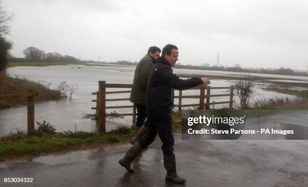 Prime Minister and MP for Witney David Cameron talks with farmer Tim Hook near Bampton, in Oxfordshire.