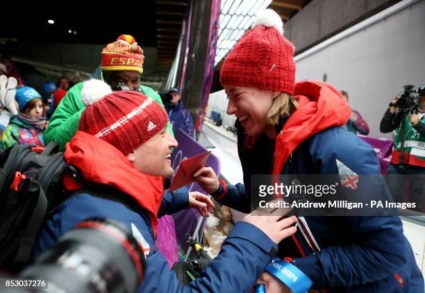 Great Britain's Lizzy Yarnold celebrates with her boyfriend James Roache after winning Gold in the Women's Skeleton Final during the 2014 Sochi...