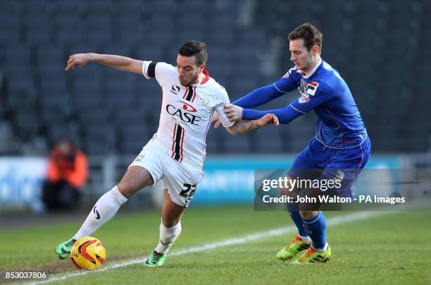 Milton Keynes Samir Carruthers and Oldham Athletic's Jonathan Grounds battles for possession of the ball during the Sky Bet League One match at...