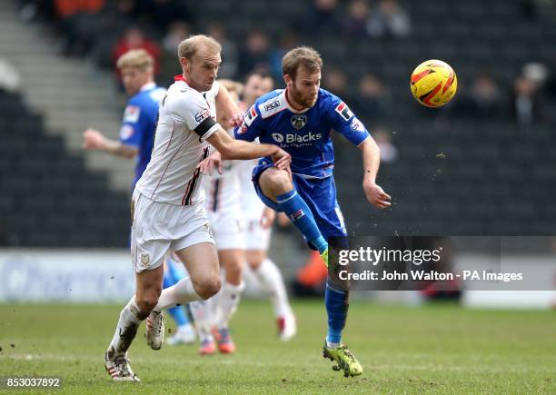 Milton Keynes Dons' Luke Chadwick and Oldham Athletic's Adam Lockwood battles for possession of the ball during the Sky Bet League One match at...