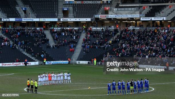 Milton Keynes and Oldham Athletic's players observe a minutes applause for the passing of former Preston North End player Tom Finney during the Sky...