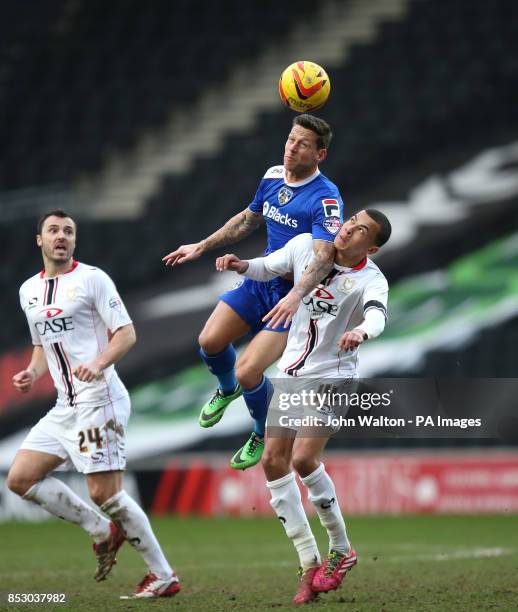 Milton Keynes Dele Alli and Oldham Athletic's Charlie Macdonald battles for possession of the ball in the air during the Sky Bet League One match at...