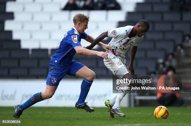 Milton Keynes' Izale McLeod battles for possession of the ball with Oldham Athletic's Adam Lockwood during the Sky Bet League One match at...