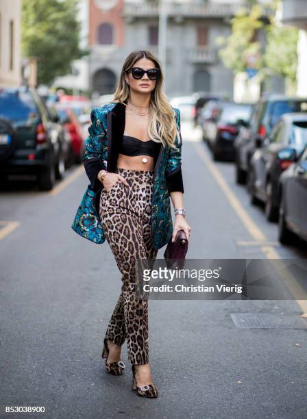 Thassia Naves wearing pants with leo print, cropped top is seen outside Dolce & Gabbana during Milan Fashion Week Spring/Summer 2018 on September 24,...