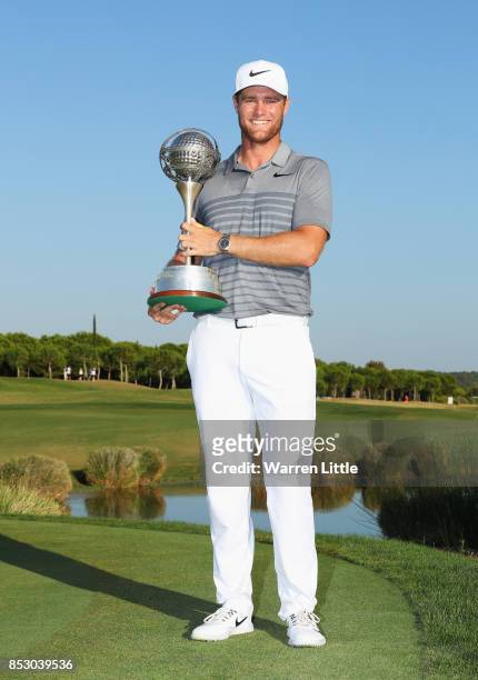 Lucas Bjerregaard of Denmark celebrates victory with the trophy during day four of the Portugal Masters at Dom Pedro Victoria Golf Club on September...
