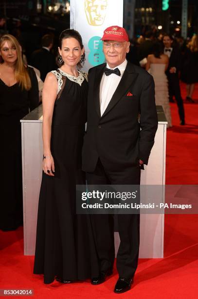 Niki Lauda and Birgit Wetzinger arriving at The EE British Academy Film Awards 2014, at the Royal Opera House, Bow Street, London.