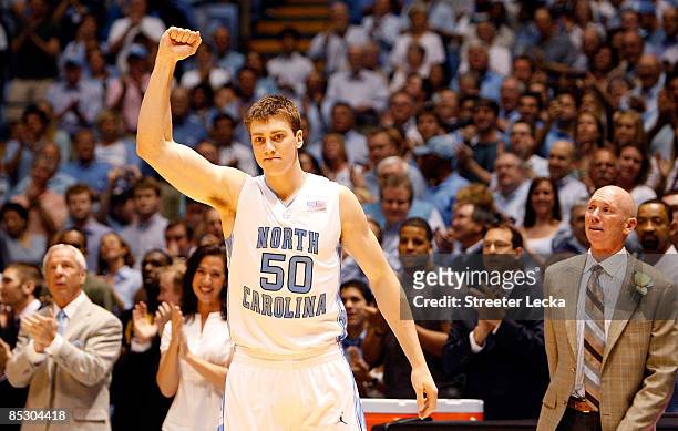 Tyler Hansbrough of the North Carolina Tar Heels thanks fans as his head coach Roy Williams and father, Gene , watch on before the start of their...