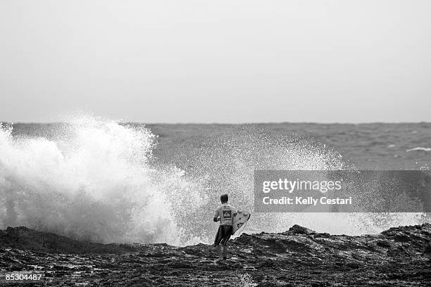 Josh Kerr of Australia faces the force of the ocean while preparing to jump off the rocks during the Quiksilver Pro Gold Coast presented by LG Mobile...