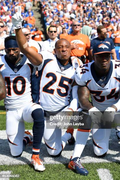 Denver Broncos wide receiver Emmanuel Sanders Denver Broncos cornerback Chris Harris and Denver Broncos defensive back Will Parks take a knee during...