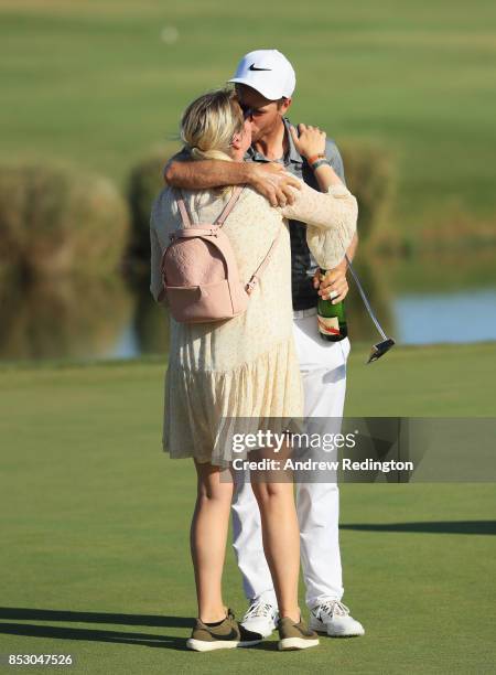 Lucas Bjerregaard of Denmark celebrates victory on the 18th green with Henriette Q. Friis Ostergaard during day four of the Portugal Masters at Dom...