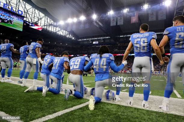 Members of the Detroit Lions take a knee during the playing of the national anthem prior to the start of the game against the Atlanta Falcons at Ford...
