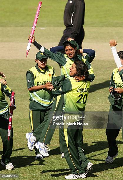 Asmavia Iqbal of Pakistan lifts team-mate Urooj Khan after winning the ICC Women's World Cup 2009 round two group stage match between Sri Lanka and...