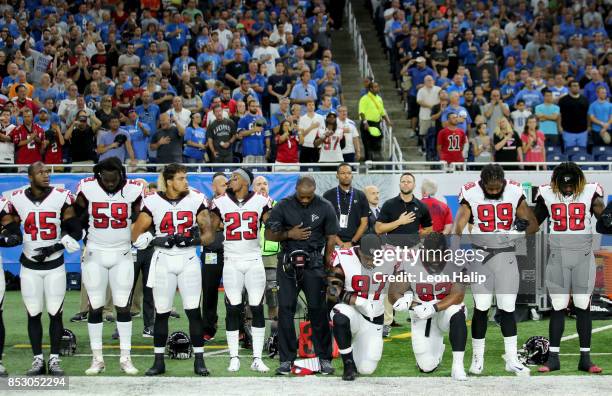 Members of the Atlanta Falcons football team Grady Jarrett and Dontari Poe take a knee during the playing of the national anthem prior to the start...