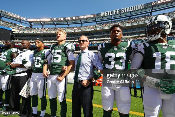 Jermaine Kearse and Josh McCown, Jamal Adams and Christopher Johnson CEO of the New York Jets stand in unison with their team during the National...