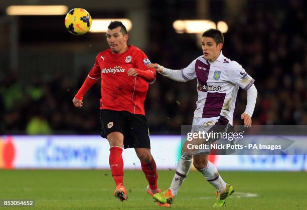 Cardiff City's Gary Medel holds off a challenge from Aston Villa's Ashley Westwood