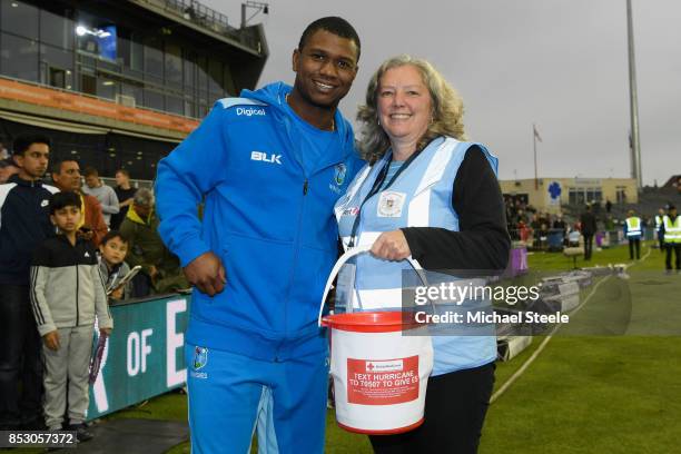 Evin Lewis of West Indies with Liz a volunteer collecting on behalf of the British Red Cross for the Hurricane appeal during the third Royal London...
