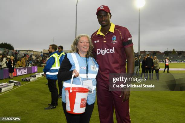 Jason Holder of West Indies with Liz a volunteer collecting on behalf of the British Red Cross for the Hurricane appeal during the third Royal London...