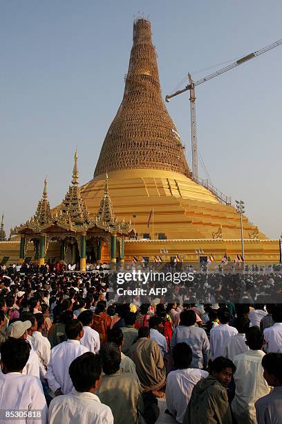 Thousands of people take part in a consecration ceremony of the Uppatasanti Pagoda, a replica of Yangon's famed Shwedagon Pagoda, in Myanmar's...