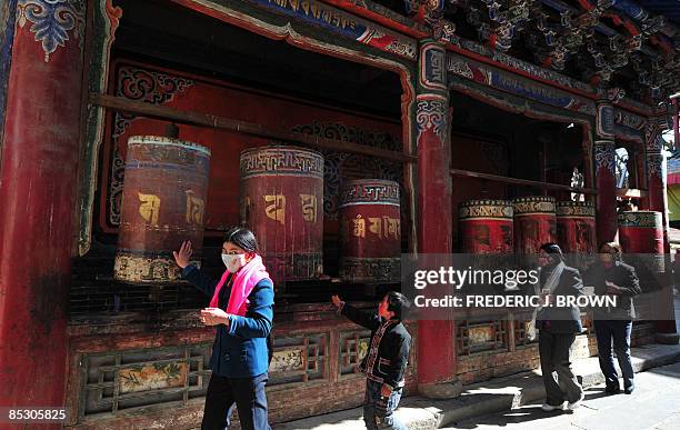 Tibetan Buddhists spin prayer wheels at the Kumbum Monastery outside of Xining on March 8, 2009 in northwest China's Qinghai province, a vast region...