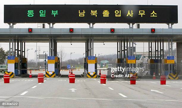 The gate for a cross-border road to North Korea is seen closed with a display of red lights on customs and immigration and Quarantine office's booth...