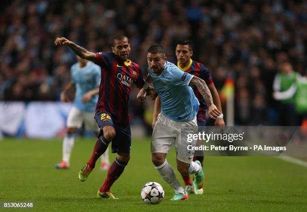 Barcelona's da Silva Dani Alves and Manchester City's Aleksandar Kolarov battle for the ball