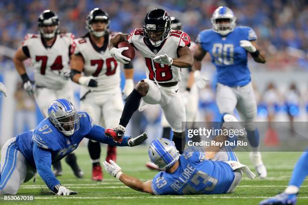 Taylor Gabriel of the Atlanta Falcons runs over Armonty Bryant of the Detroit Lions and Nick Bellore during the first quarter action at Ford Field on...
