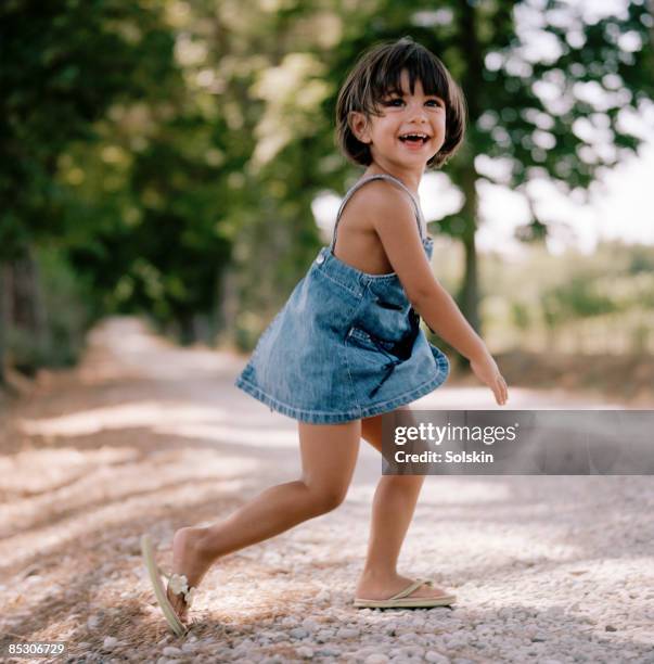 running girl, laughing - girls wearing sandals stock-fotos und bilder