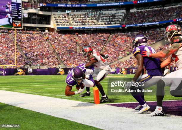 Jarius Wright of the Minnesota Vikings dives in to the end zone with the ball for a touchdown in the second quarter of the game agains the Tampa Bay...