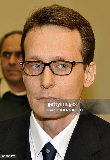 Helg Scarbi, dubbed the "Swiss Gigolo", waits at court for the start of his trial on March 9, 2009 in Munich, southern Germany, where he is accused...