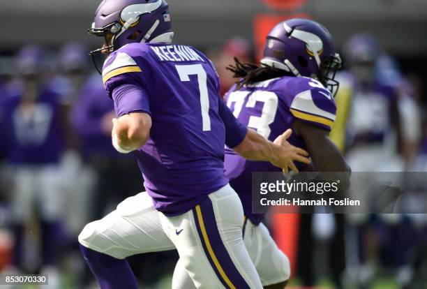 Case Keenum of the Minnesota Vikings hands the ball off to Dalvin Cook in the first quarter of the game against the Tampa Bay Buccaneers on September...