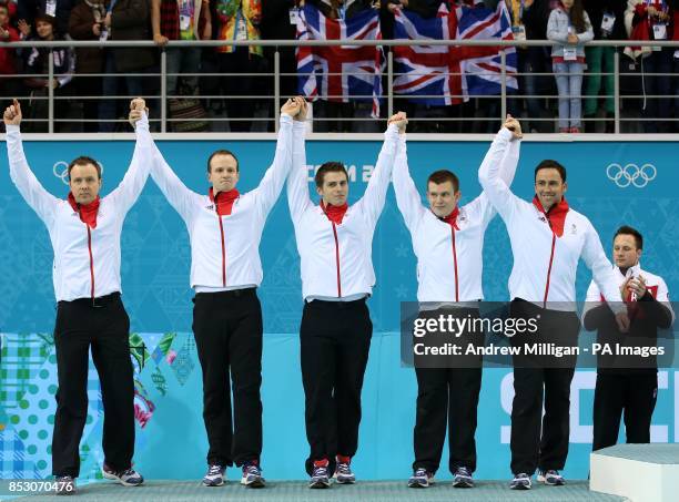 Great Britain's Tom Brewster, Michael Goodfellow, Scott Andrews, Greg Drummond and David Murdoch step on to the podium for the flower ceremony after...