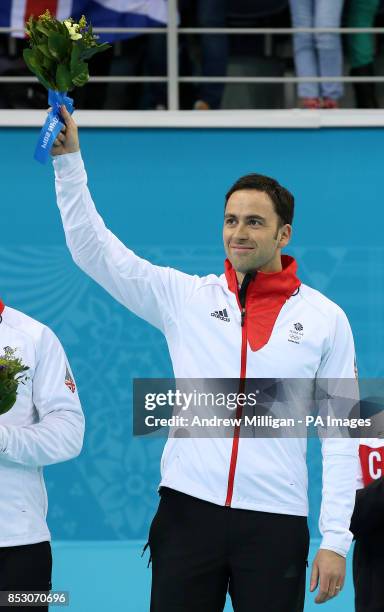 Great Britain's skip David Murdoch steps on to the podium for the flower ceremony after taking Silver in the Men's Gold medal match at the Ice Cube...