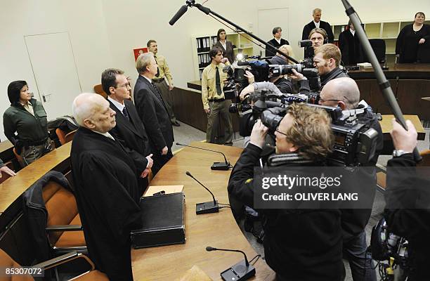 Helg Scarbi, dubbed the "Swiss Gigolo", and his lawyer Egon Geis and Till Gonterweiler face photographers and cameramen as they wait at court for the...