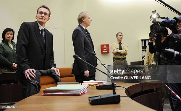 Helg Scarbi , dubbed the "Swiss Gigolo", and his lawyer Till Gonterweiler face photographers and cameramen as they wait at court for the start of his...