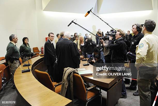 Helg Scarbi, dubbed the "Swiss Gigolo", and his lawyer Egon Geis and Till Gonterweiler face photographers and cameramen as they wait at court for the...