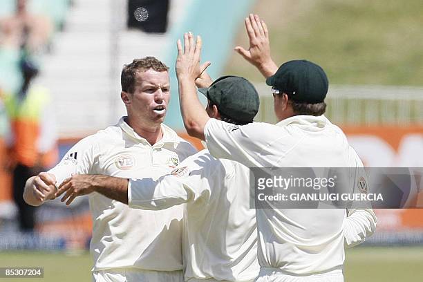 Australian bowler Peter Siddle celebrates with his teammates the dismissal of South African batsman Neil Mckenzie on March 9, 2009 during the fourth...