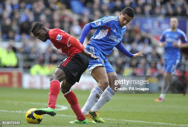 Cardiff City's Wilfried Zaha and Hull City's Curtis Davies during the Barclays Premier League match at The Cardiff City Stadium, Cardiff.