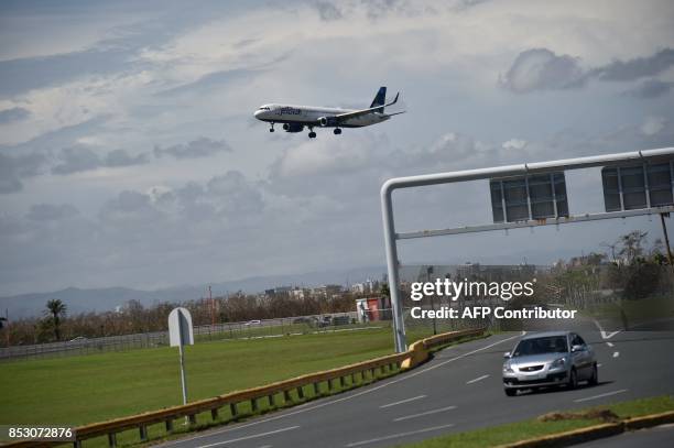 An airplane arrives to Luis Munoz Marin International Airport, in San Juan, Puerto Rico, on September 24, 2017. / AFP PHOTO / HECTOR RETAMAL