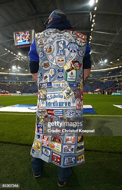 Fan of Schalke in a jeans jacket with fan stickers is seen before the Bundesliga match between FC Schalke 04 and 1. FC Koeln at the Veltins-Arena on...