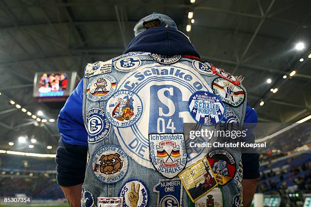 Fan of Schalke in a jeans jacket with fan stickers is seen before the Bundesliga match between FC Schalke 04 and 1. FC Koeln at the Veltins-Arena on...