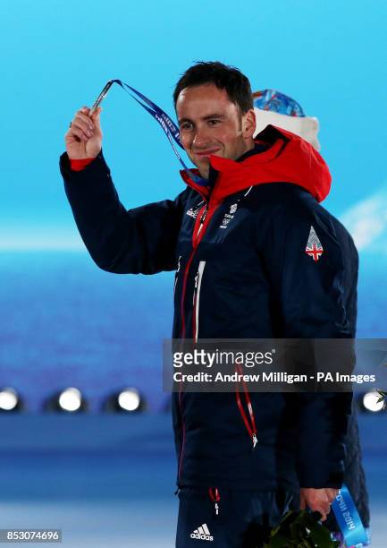 Great Britain's Men's curling team skip David Murdoch holds up his silver medal during the medal ceremony at the Medals Plaza, after they won Silver...