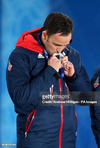 Great Britain's Men's curling team skip David Murdoch kisses his silver medal during the medal ceremony at the Medals Plaza, during the 2014 Sochi...