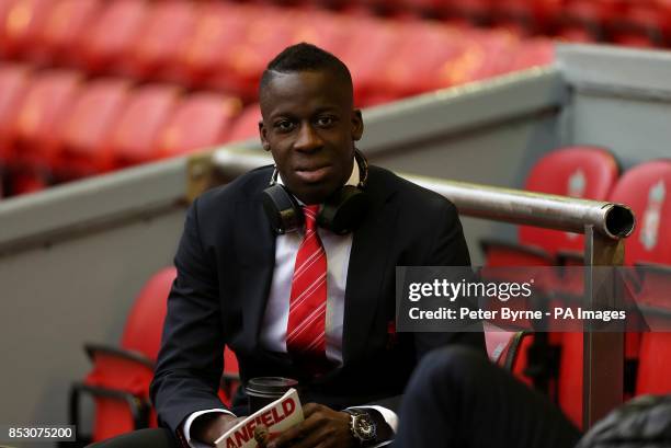 Liverpool's Aly Cissokho reads the match day program