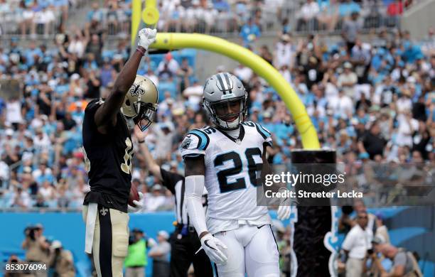 Brandon Coleman of the New Orleans Saints reacts after scoring a touchdown as Daryl Worley of the Carolina Panthers watches on during their game at...