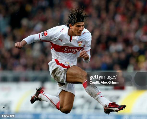 Mario Gomez of Stuttgart jumps to shoot the ball during the Bundesliga match between VfB Stuttgart and Borussia Dortmund at the Mercedes-Benz Arena...