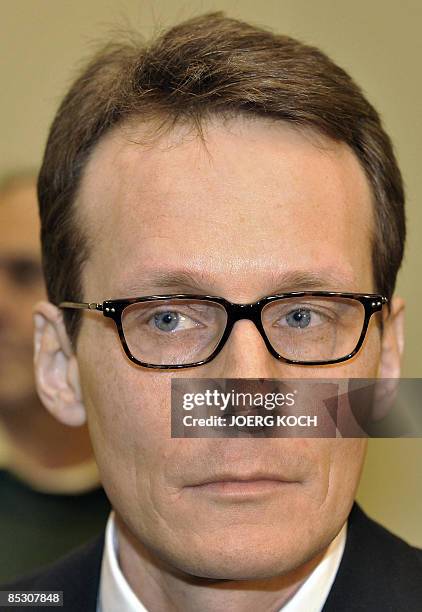 Helg Scarbi, dubbed the "Swiss Gigolo", waits at court for the start of his trial on March 9, 2009 in Munich, southern Germany, where he is accused...