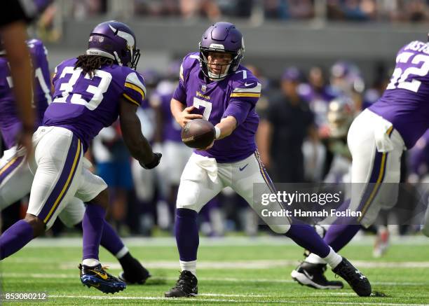 Case Keenum of the Minnesota Vikings hands the ball off to Dalvin Cook in the first half of the game agains the Tampa Bay Buccaneers on September 24,...