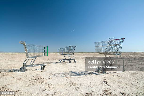 shopping carts in rural,barren landscape. - abandoned cart stock pictures, royalty-free photos & images