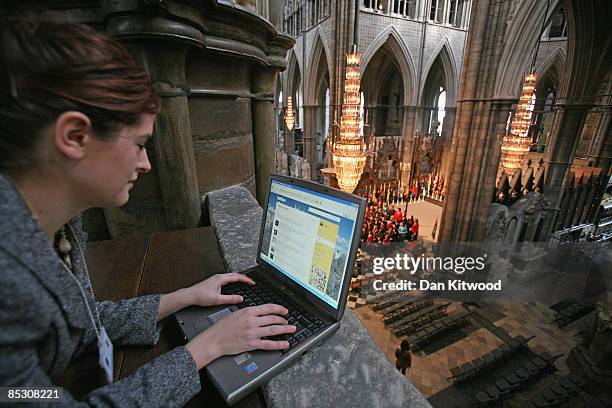 Westminster Abbey's online editor Imogen Levy uses the micro blog site, 'Twitter' during rehearsals ahead of the Commonwealth Observance at...