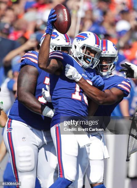 Andre Holmes of the Buffalo Bills celebrates with teammates Cordy Glenn and Zay Jones after scoring a touchdown in the second quarter of an NFL game...